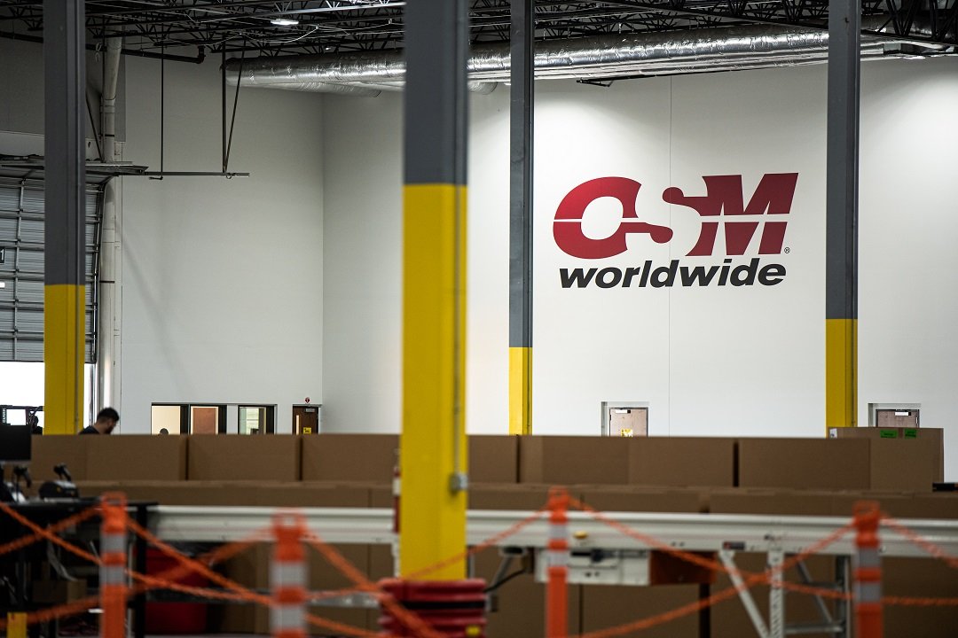 OSM Worldwide warehouse interior with sorting conveyor and branding, industrial photography Dallas, Texas