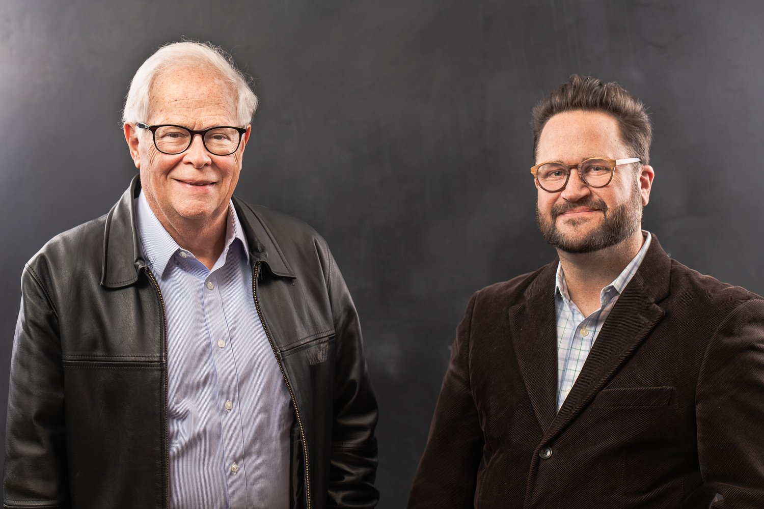 Two men in glasses posing for professional portrait photography in Dallas, Texas