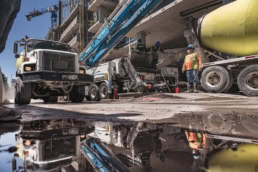 TAS Concrete mixer truck and pump at construction site, industrial photography Houston, Texas
