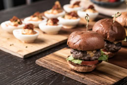 Gourmet sliders and deviled eggs on wooden boards, food photography Dallas, Texas