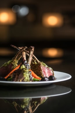 Herb-crusted rack of lamb with roasted vegetables, food photography Dallas, Texas
