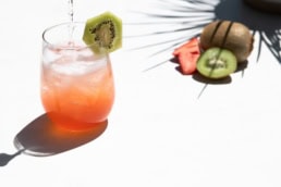 Strawberry kiwi cocktail with fresh fruit garnish, food and beverage photography Dallas, Texas