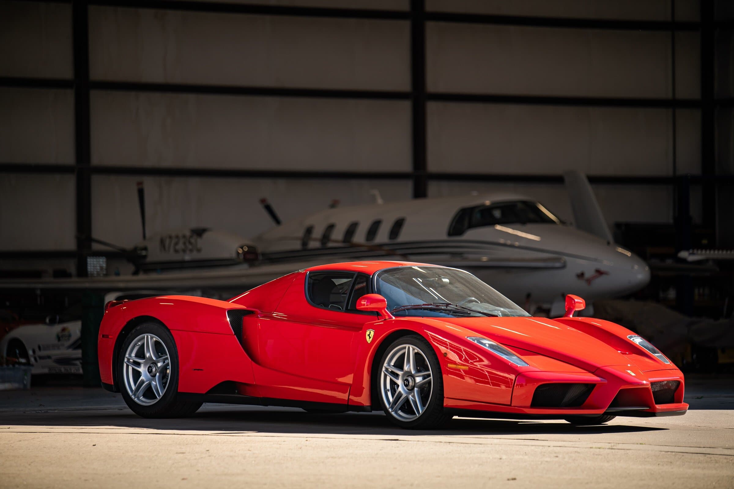 Red Ferrari Enzo in aircraft hangar, automotive photography Dallas, Texas