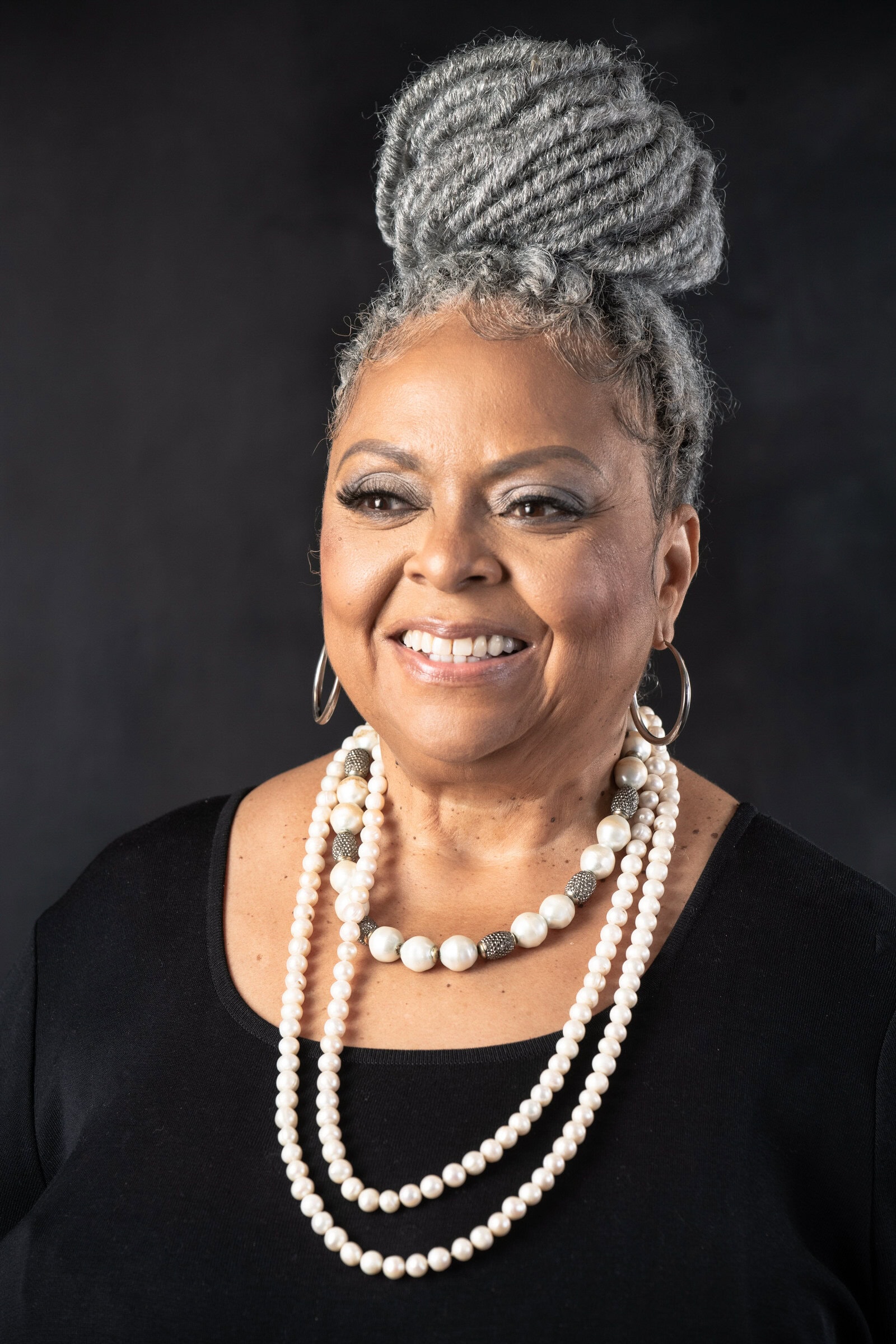 Elegant woman with silver updo and pearl necklaces, professional portrait photography Dallas, Texas