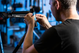 Technician applying decal to bicycle frame head tube, industrial photography Dallas, Texas