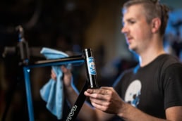 Technician inspecting bicycle frame head tube in workshop, industrial photography Dallas, Texas