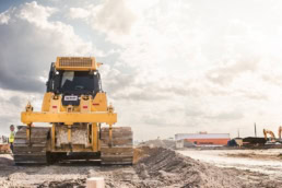 Yellow bulldozer on construction site, industrial photography Dallas, Texas — David Loi Studios