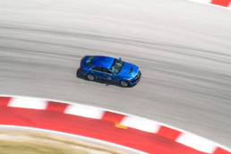 Blue Cadillac CT5-V racing at Circuit of the Americas, automotive photography Austin, Texas