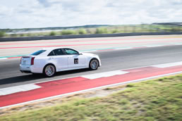 White Cadillac CTS-V number 13 on track at Circuit of the Americas, automotive photography Austin, Texas
