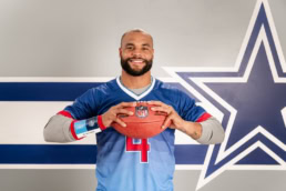 Dak Prescott holding NFL football for Lowe's DIY campaign, commercial photography Dallas, Texas