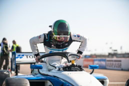 Indy Lights racing driver climbing into open-wheel car, motorsport photography Dallas, Texas