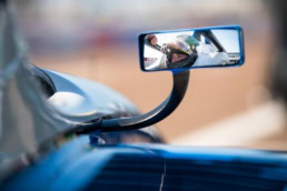 Indy Lights racing driver reflected in side mirror, motorsport photography Dallas, Texas