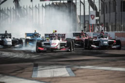 Indy Lights open-wheel race cars battling into turn one, motorsport photography Dallas, Texas