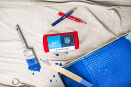 Lowe's NFL DIY Wrist Coach with blue paint and brushes, commercial product photography Dallas, Texas