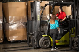 OSM Worldwide warehouse workers with Clark forklift, industrial photography Dallas, Texas