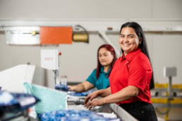 OSM Worldwide workers sorting packages on production line, industrial photography Dallas, Texas