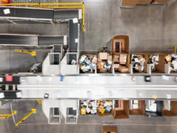 OSM Worldwide package sorting facility overhead view, industrial photography Dallas, Texas
