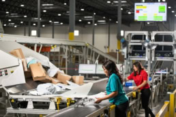 OSM Worldwide package sorting facility workers on conveyor belt, industrial photography Dallas, Texas