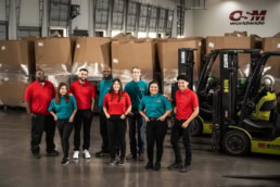 OSM Worldwide warehouse team with Clark forklifts, commercial photography Dallas, Texas