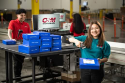 OSM Worldwide warehouse workers scanning Book of the Month boxes, commercial photography Dallas, Texas