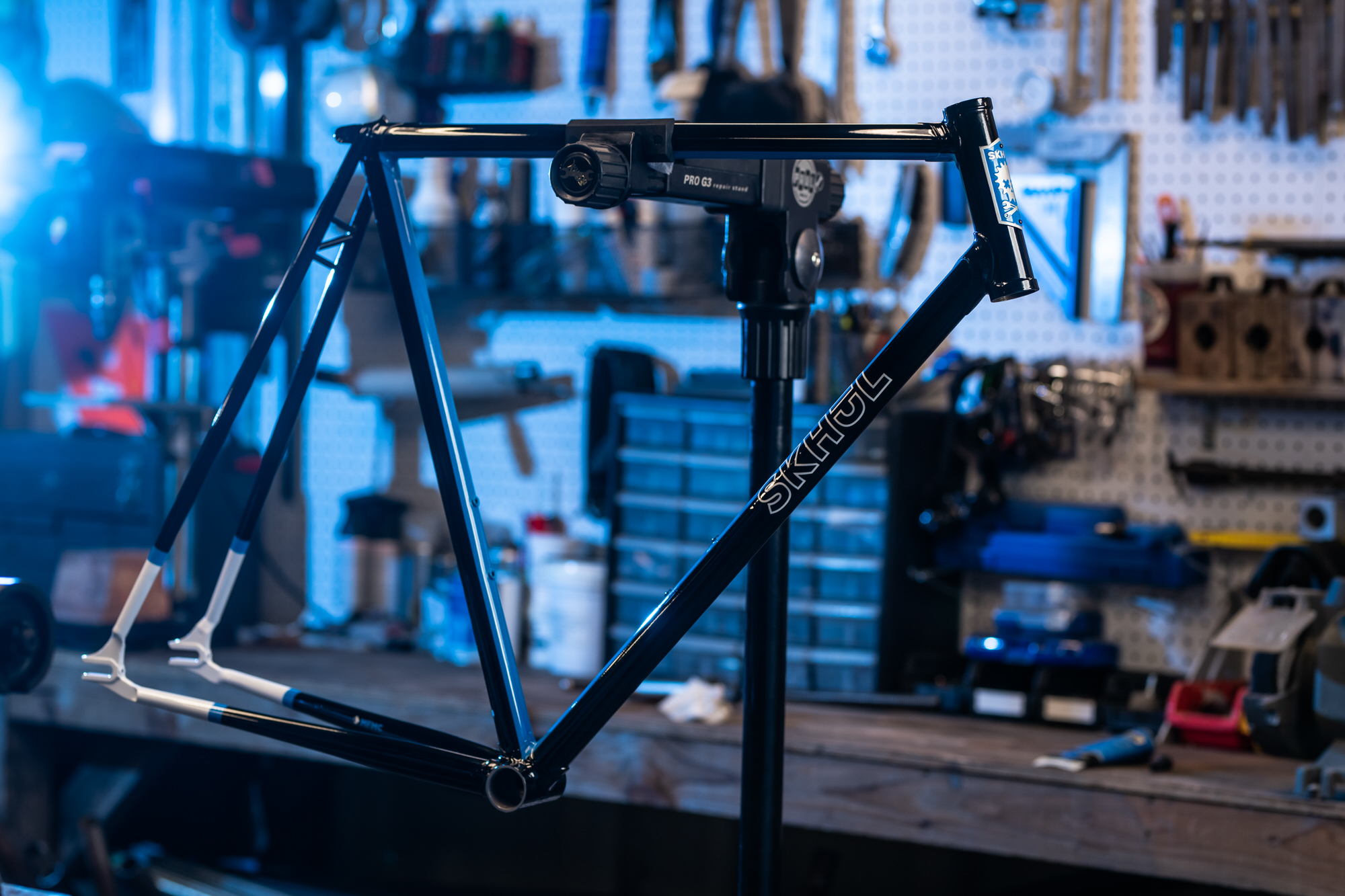SKHUL Bicycles steel frame on repair stand in workshop, commercial product photography Dallas, Texas