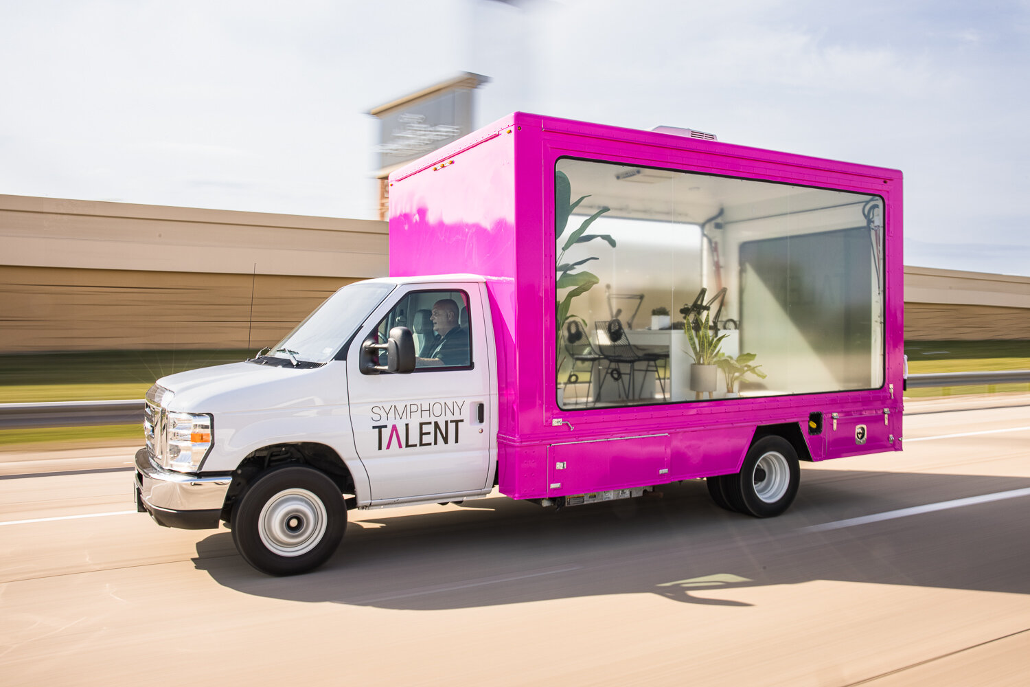Symphony Talent branded pink box truck with glass-walled mobile office, commercial photography Dallas, Texas
