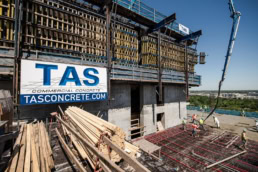 TAS Commercial Concrete construction site with workers pouring concrete, industrial photography Houston, Texas