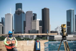 TAS Concrete construction worker with surveying equipment, industrial photography Houston, Texas