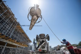 TAS Concrete crane lifting concrete bucket at construction site, industrial photography Houston, Texas