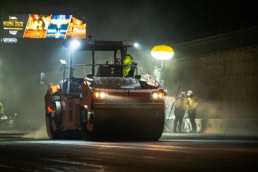 Topcon road roller compacting asphalt at night, industrial photography Fort Worth, Texas