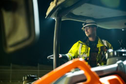 Topcon heavy equipment operator in high-vis gear, industrial photography Fort Worth, Texas