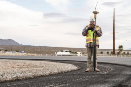 Topcon GPS surveyor with rover pole on construction site, industrial photography Fort Worth, Texas