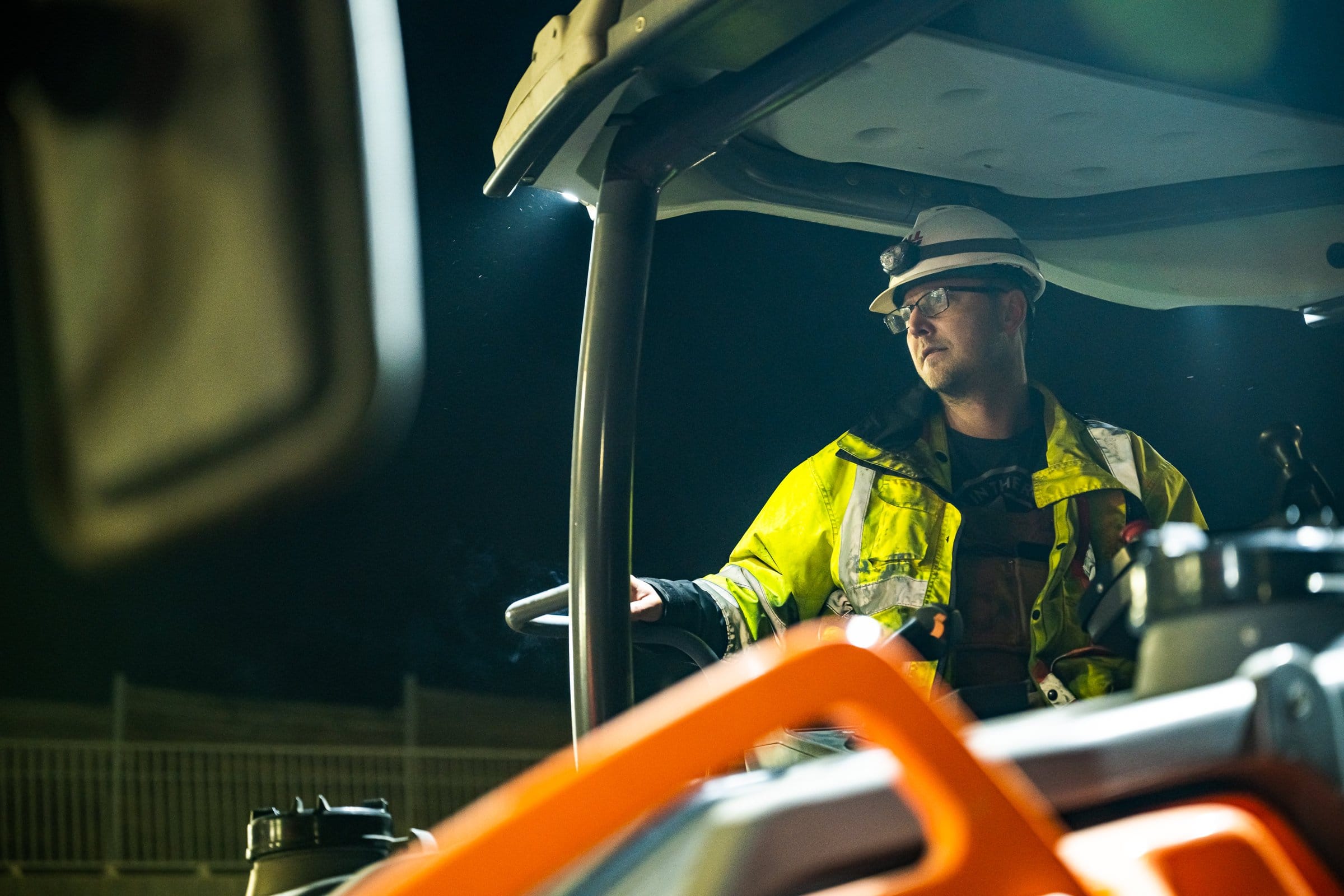 Topcon heavy equipment operator in high-visibility gear, industrial photography Fort Worth, Texas