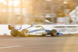 Topcon-sponsored Indy Lights car #12 racing at speed, automotive photography Dallas, Texas