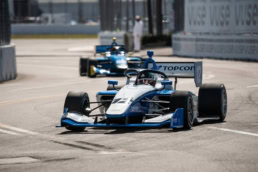 Topcon Indy Lights car #12 racing on street circuit, automotive photography Dallas, Texas
