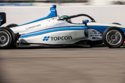 Topcon-sponsored Indy Lights race car at speed, automotive photography Dallas, Texas