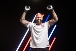 Tim Howard, athlete celebrating in USA jersey and goalkeeper gloves, American Airlines x US Soccer portrait Dallas, Texas