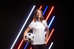 Carli Lloyd athlete in USA jersey holding soccer ball, American Airlines x US Soccer portrait photography Dallas, Texas