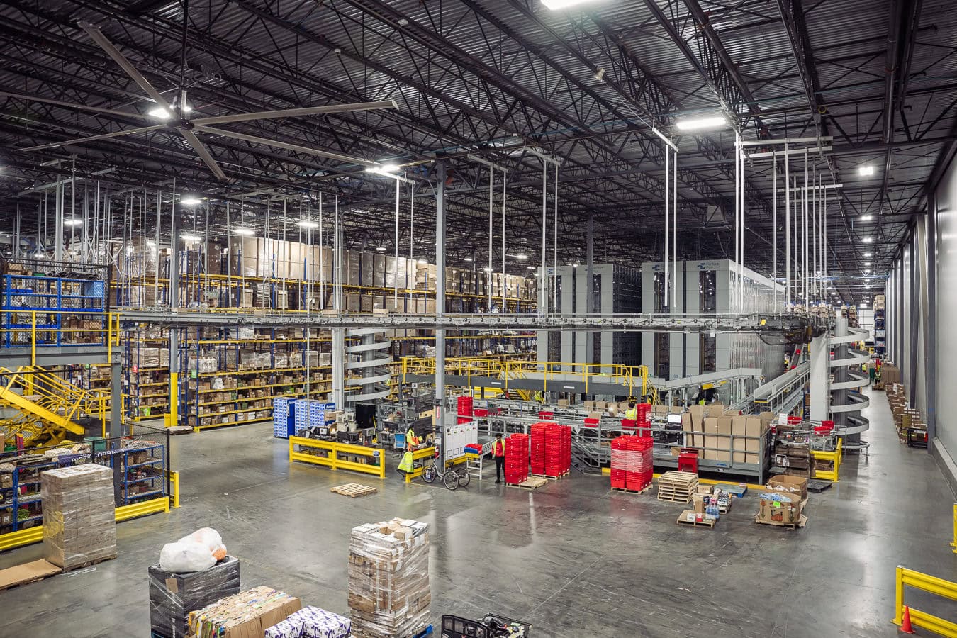 Automated conveyor systems inside warehouse fulfillment center, industrial photography