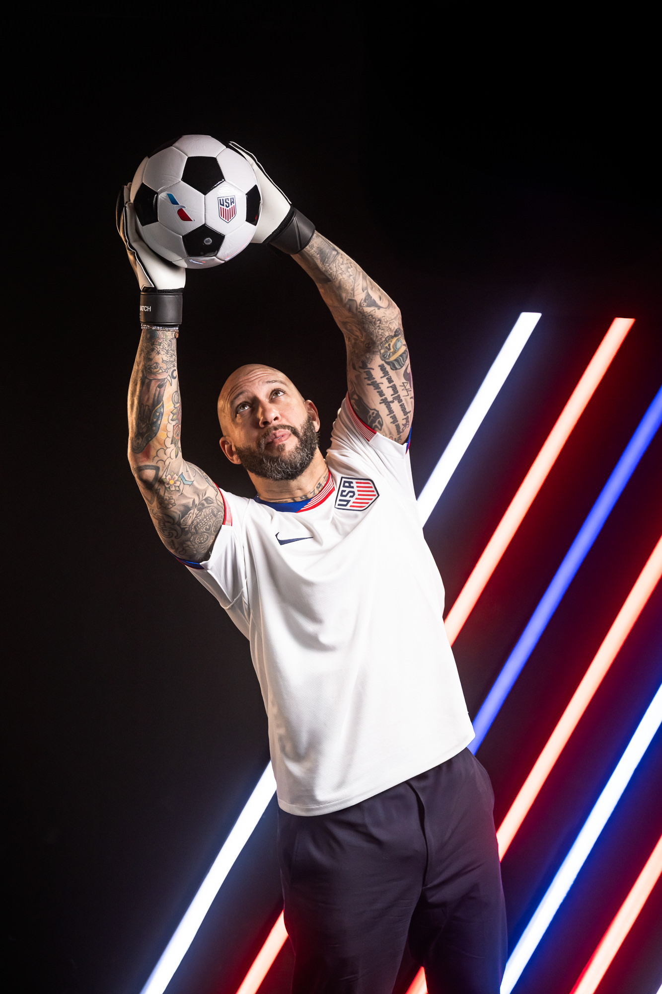 Tim Howard US Soccer goalkeeper with tattoos holding ball, American Airlines x US Soccer commercial photography Dallas, Texas