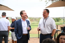 Two professionals networking with drinks at corporate event, event photography Dallas, Texas