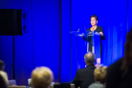 Professional speaker at podium during corporate event, event photography Dallas, Texas