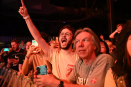 Excited concert crowd cheering at live event, event photography Dallas, Texas
