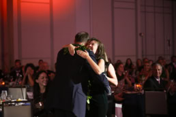 Two guests embracing at a gala event, Dallas events photography by David Loi Studios