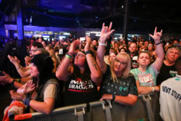 Imagine Dragons concert crowd with fans in band shirts, event photography Dallas, Texas