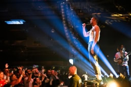Imagen Dragons performing live on stage with crowd at Dallas, Texas concert event photography