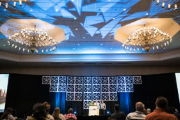 OneRD corporate event stage presentation with speakers at podium, event photography Dallas, Texas