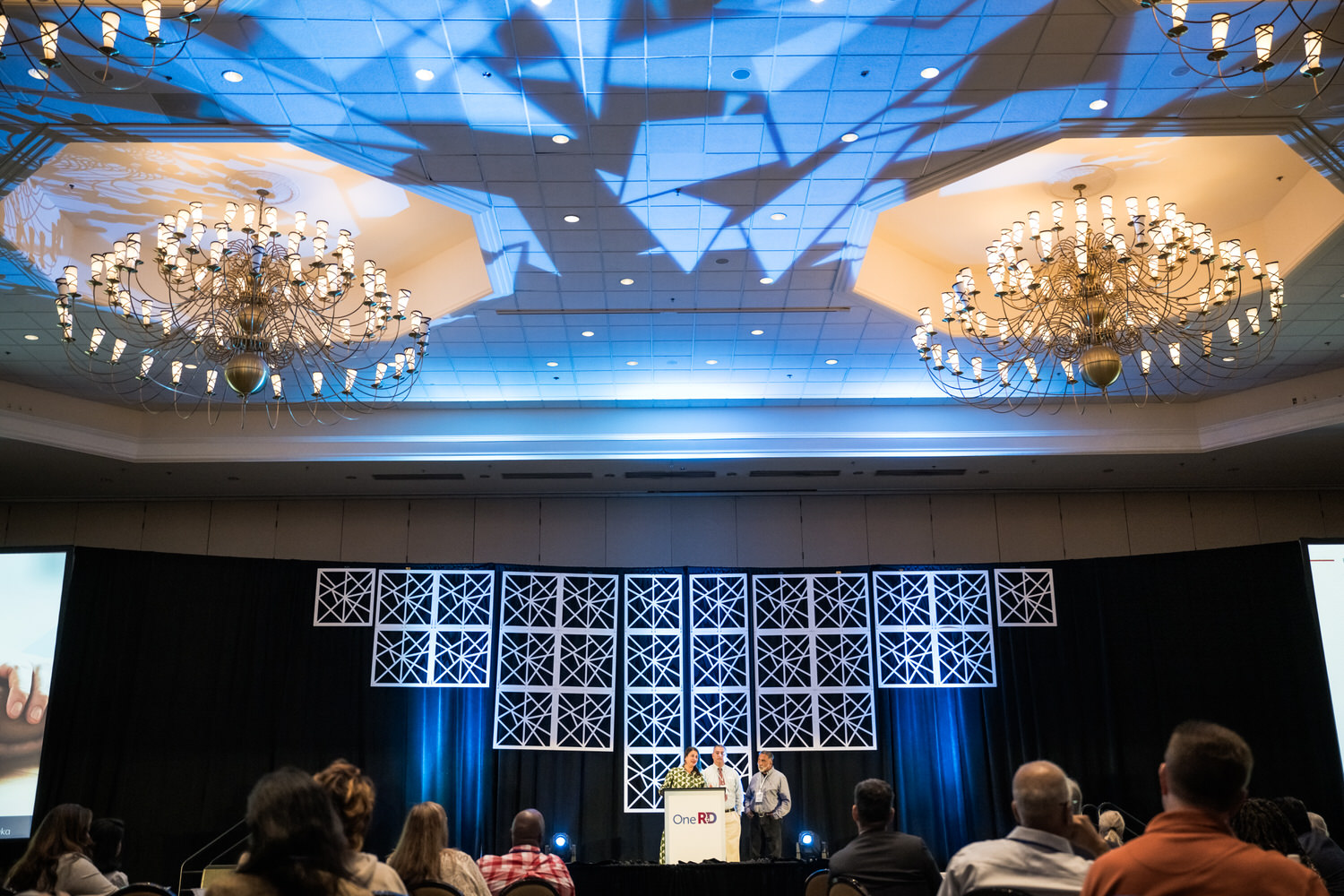 OneRD corporate event stage presentation with speakers at podium, event photography Dallas, Texas