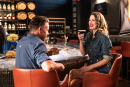 Couple enjoying cocktails at Blackland Distillery bar, commercial photography Fort Worth, Texas