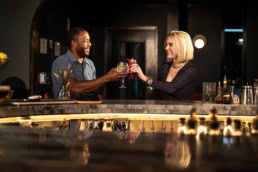 Couple toasting cocktails at Blackland Distillery bar, commercial photography Fort Worth, Texas